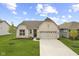 Charming single-story brick home with a manicured lawn, a two-car garage, and a welcoming entrance at 9696 Parkhurst Xing, McCordsville, IN 46055