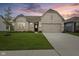 Charming single-story home with a well-manicured lawn, neutral brick, and an attached two-car garage at 9696 Parkhurst Xing, McCordsville, IN 46055