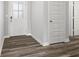 Hallway with wood floors, a glass paneled front door, and a view of interior doors at 9696 Parkhurst Xing, McCordsville, IN 46055