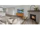 Comfortable living room featuring a fireplace, tv, windows, and modern furnishings at 9696 Parkhurst Xing, McCordsville, IN 46055