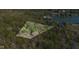 Aerial view of property with tree coverage, highlighting its peaceful setting and location near the water at 9806 Raintree N Dr, Columbus, IN 47201