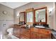 Spacious bathroom featuring double vanities with granite counters and rustic, painted brick walls at 9806 Raintree N Dr, Columbus, IN 47201