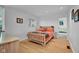 Well-lit bedroom with hardwood floors and access to an adjacent sitting room at 9806 Raintree N Dr, Columbus, IN 47201