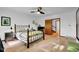 Bright bedroom with hardwood floors, ceiling fan, and access to a second story hallway at 9806 Raintree N Dr, Columbus, IN 47201