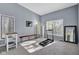 Sunlit bonus room with neutral carpet, multiple windows, and space for exercise equipment at 9806 Raintree N Dr, Columbus, IN 47201