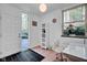 Inviting entryway with tile floors, natural light, and an adjacent home office space at 9806 Raintree N Dr, Columbus, IN 47201