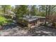 Well-maintained exterior with a spacious driveway and attached garage, surrounded by trees at 9806 Raintree N Dr, Columbus, IN 47201