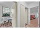 Bright hallway with hardwood floors, and a view of the home office and bedroom at 9806 Raintree N Dr, Columbus, IN 47201