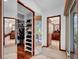 Hallway with walk-in closet leading to a bathroom at 9806 Raintree N Dr, Columbus, IN 47201
