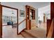 Hallway featuring wood floors, staircase, and built in shelves at 9806 Raintree N Dr, Columbus, IN 47201