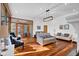 Bright living room featuring hardwood floors, stylish seating, and access to an outdoor area through glass doors at 9806 Raintree N Dr, Columbus, IN 47201