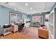 Sun-drenched home office with multiple windows, natural light, and built-in shelving at 9806 Raintree N Dr, Columbus, IN 47201