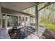 Covered patio providing a comfortable outdoor seating area with nature views and stone floors at 9806 Raintree N Dr, Columbus, IN 47201