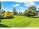 Expansive backyard with lush green lawn, mature trees, and privacy fence; perfect for outdoor enjoyment at 10746 Gateway Dr, Fishers, IN 46037