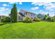 Expansive backyard featuring a lush lawn, mature trees, and beautiful landscaping; perfect for outdoor activities at 10746 Gateway Dr, Fishers, IN 46037