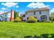 Spacious backyard showcases a vibrant lawn and features mature landscaping, perfect for outdoor living at 10746 Gateway Dr, Fishers, IN 46037