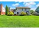 Large backyard offers a well-maintained lawn, mature landscaping, and a cozy deck for entertaining at 10746 Gateway Dr, Fishers, IN 46037
