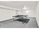 Well-lit basement featuring a ping pong table and potential for a game room at 10746 Gateway Dr, Fishers, IN 46037
