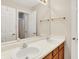 Bathroom with double sinks, a mirror, tan cabinetry, and gold towel bars at 10746 Gateway Dr, Fishers, IN 46037