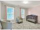 Bedroom with two large windows, a crib, two accent chairs and pink and grey accent walls at 10746 Gateway Dr, Fishers, IN 46037