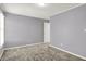 Standard bedroom with a window, neutral paint color, white trim, and neutral carpet at 10746 Gateway Dr, Fishers, IN 46037