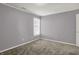 Standard bedroom with a window, neutral paint color, white trim, and neutral carpet at 10746 Gateway Dr, Fishers, IN 46037