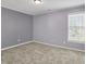 Standard bedroom with a window, neutral paint color, white trim, and neutral carpet at 10746 Gateway Dr, Fishers, IN 46037