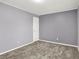 Clean bedroom with a white door, neutral carpet and neutral paint with white trim at 10746 Gateway Dr, Fishers, IN 46037