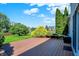 Inviting deck area with built-in seating, surrounded by mature landscaping and lush greenery at 10746 Gateway Dr, Fishers, IN 46037
