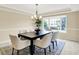 Formal dining room with a modern chandelier, elegant rug, and bay window with lush outdoor views at 10746 Gateway Dr, Fishers, IN 46037
