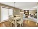Bright dining area with natural light and hardwood floors that leads into a cozy living room at 10746 Gateway Dr, Fishers, IN 46037