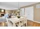 Dining area with white table and chairs that leads into the living room at 10746 Gateway Dr, Fishers, IN 46037