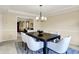 Elegant dining room showcasing ample seating, stylish chandelier, and seamless flow into adjacent living spaces at 10746 Gateway Dr, Fishers, IN 46037