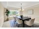 Charming dining area featuring a chandelier, large table, and a window providing abundant natural light at 10746 Gateway Dr, Fishers, IN 46037