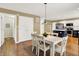 Dining area with white table and chairs that leads into the kitchen at 10746 Gateway Dr, Fishers, IN 46037