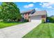 Traditional brick home with an attached two car garage and a large driveway at 10746 Gateway Dr, Fishers, IN 46037