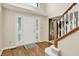 Welcoming foyer with a bright front door, hardwood floors, and staircase at 10746 Gateway Dr, Fishers, IN 46037