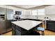 Bright kitchen features stainless steel appliances, white cabinets, and a large island with quartz countertops at 10746 Gateway Dr, Fishers, IN 46037