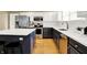 Bright kitchen with white cabinets, stainless steel appliances, and a functional island offering ample counter space at 10746 Gateway Dr, Fishers, IN 46037