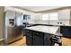 Stylish kitchen showcasing stainless steel appliances, modern finishes, and a center island with barstool seating at 10746 Gateway Dr, Fishers, IN 46037