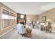 Comfortable living room with a fireplace, neutral tones, and lots of natural light at 10746 Gateway Dr, Fishers, IN 46037