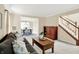 Inviting living room with comfortable seating, hardwood floors, and an open view to the dining area at 10746 Gateway Dr, Fishers, IN 46037