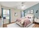 Relaxing bedroom with a queen size bed, soft natural lighting, a ceiling fan, and stylish wall decor at 10992 Chapel Woods S Blvd, Noblesville, IN 46060