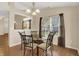 Inviting dining room featuring a glass table, six chairs, and large windows with sheer curtains at 10992 Chapel Woods S Blvd, Noblesville, IN 46060