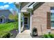 Inviting entryway with a glass storm door, brick facade, and trimmed greenery for curb appeal at 10992 Chapel Woods S Blvd, Noblesville, IN 46060
