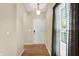 Warm entryway with light wood floors, a white front door, and sheer curtains at 10992 Chapel Woods S Blvd, Noblesville, IN 46060