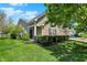 Lovely home featuring mature trees, trimmed bushes, and a well-manicured lawn showcasing curb appeal at 10992 Chapel Woods S Blvd, Noblesville, IN 46060