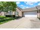 Attractive brick home with an attached two-car garage, a well-kept lawn, and manicured greenery at 10992 Chapel Woods S Blvd, Noblesville, IN 46060