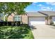 Charming brick home with a two-car garage, manicured lawn, and lush green landscaping on a sunny day at 10992 Chapel Woods S Blvd, Noblesville, IN 46060