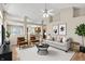 Bright living room with a ceiling fan, neutral decor, and an open floor plan at 10992 Chapel Woods S Blvd, Noblesville, IN 46060